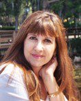 A woman with long red hair and bangs.