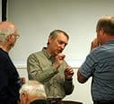 A group of men standing around each other.